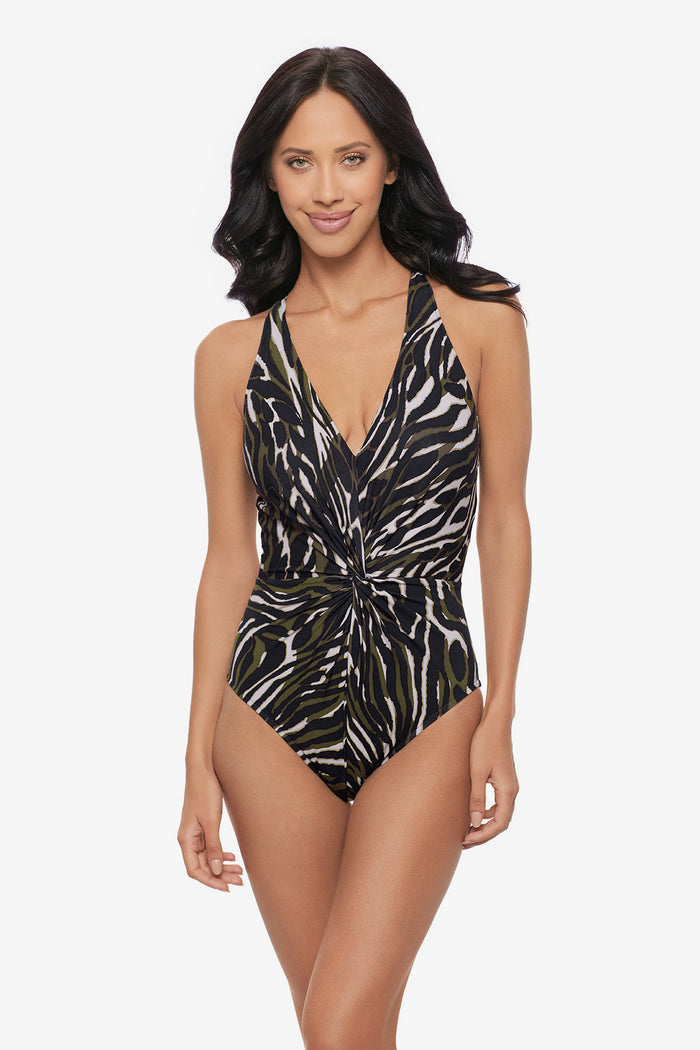 Woman wearing a multicolored animal print one-piece swimsuit