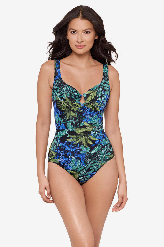 Woman wearing a multicolor one-piece swimsuit with an abstract print