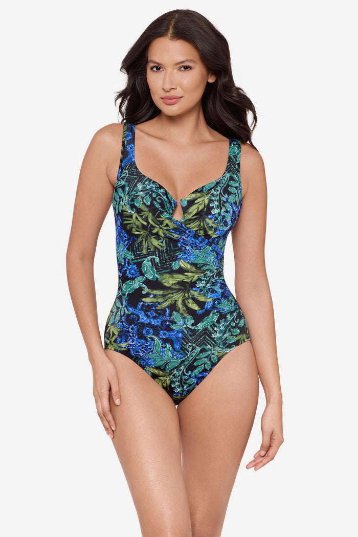 Woman wearing a multicolor one-piece swimsuit with an abstract print
