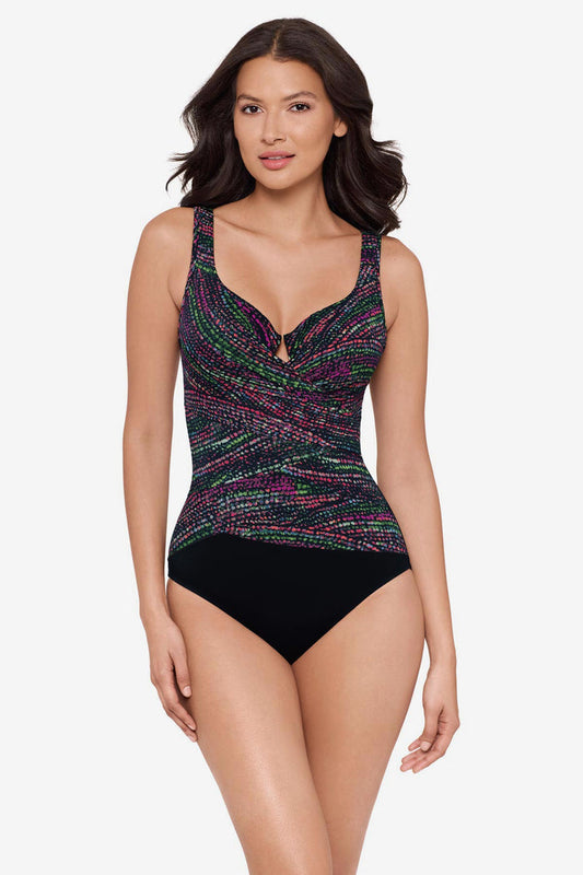 Woman wearing a multicolor one-piece swimsuit with a black panel at the bottom