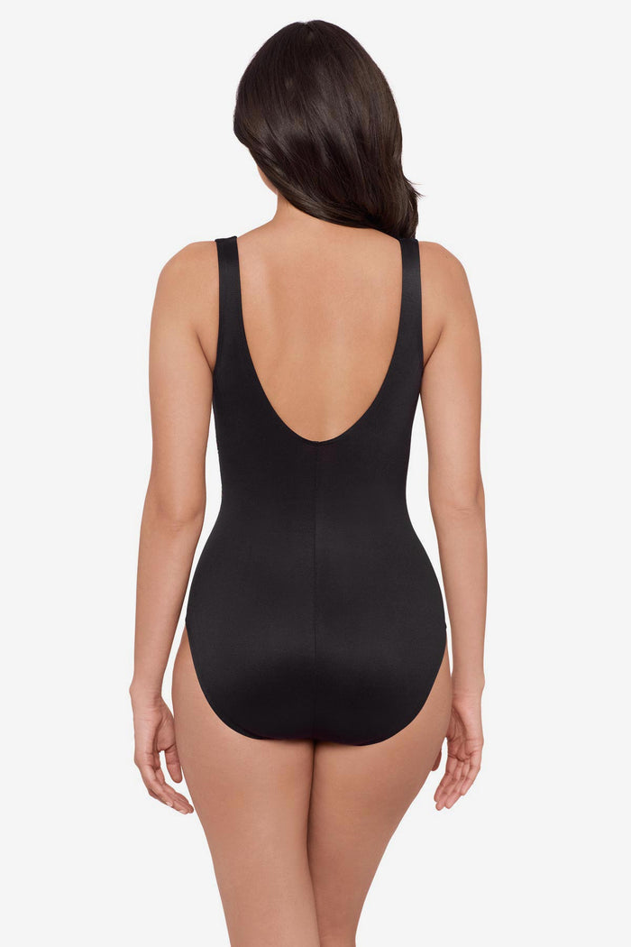 Woman turned away wearing a multicolor one-piece swimsuit