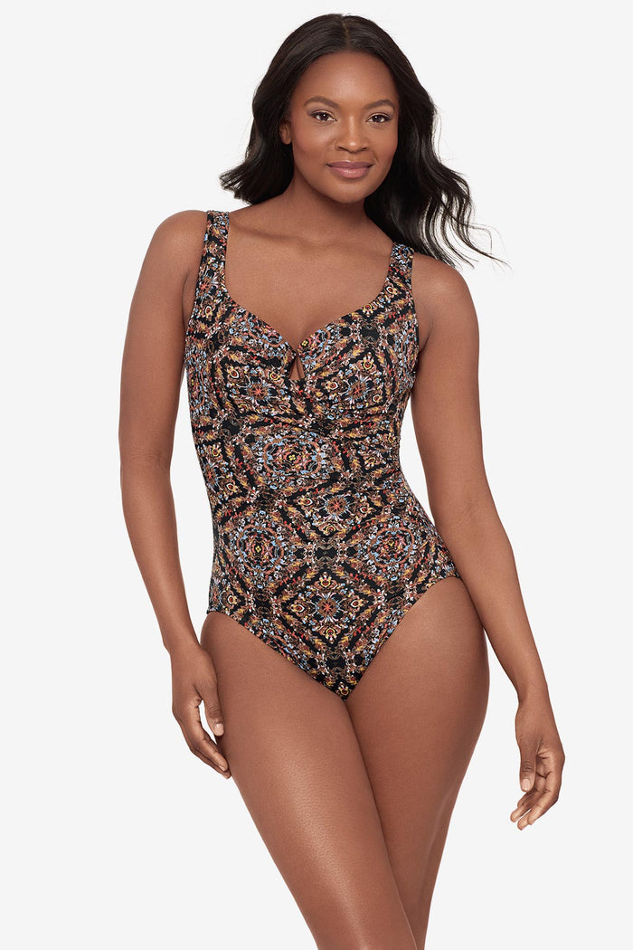 Woman wearing a multicolor abstract one-piece swimsuit with a sweetheart neckline