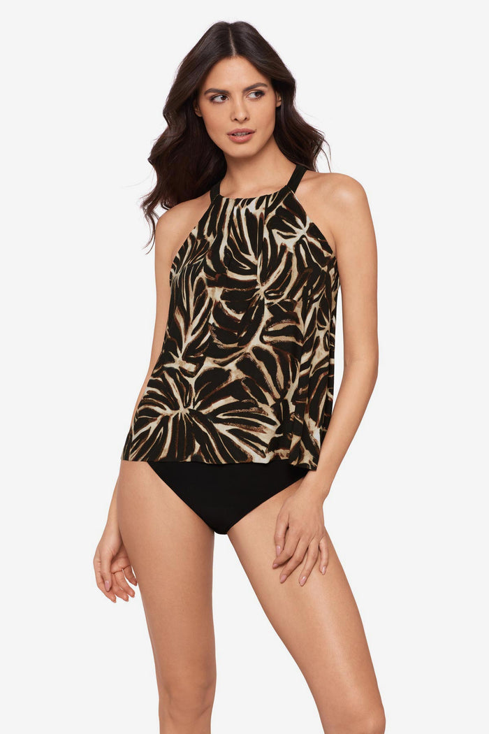 Woman wearing a brown leaf printed tankini top with a high neckline
