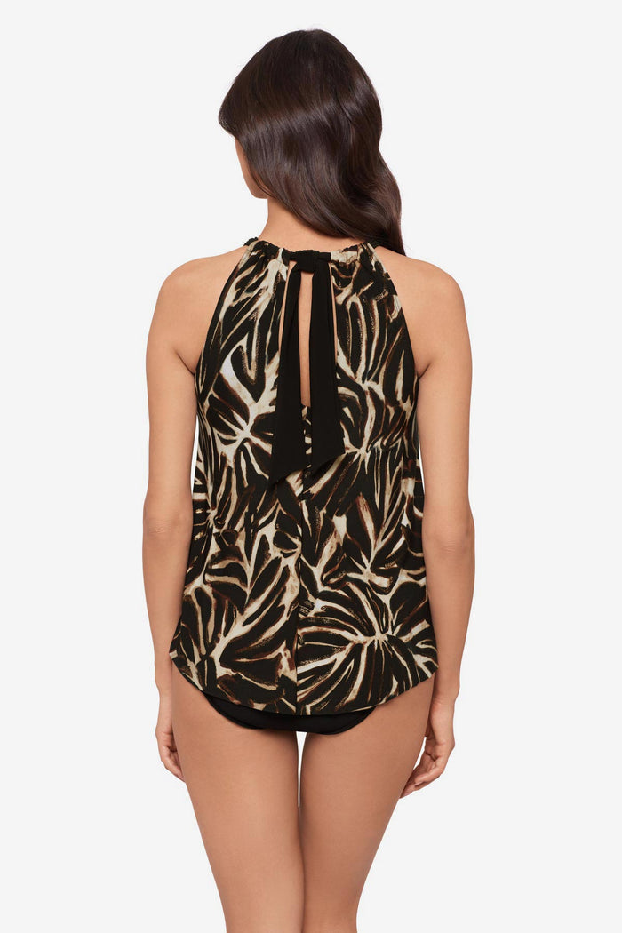 Woman turned away wearing a brown leaf printed tankini top with a tie on the back