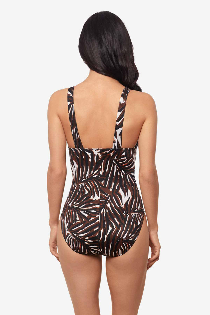 Woman facing away wearing a multicolor one-piece swimsuit