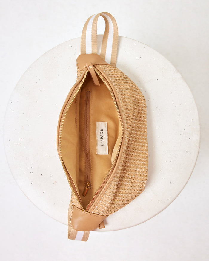 Interior view of the Evie Fanny Pack in natural, open and showing the LSPACE branded lining and inner zipper pocket.