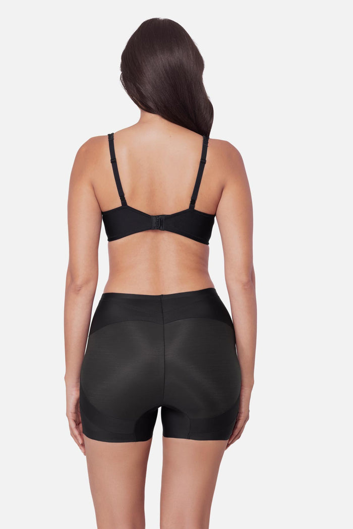 Woman turned away wearing a black boy short shapewear pant