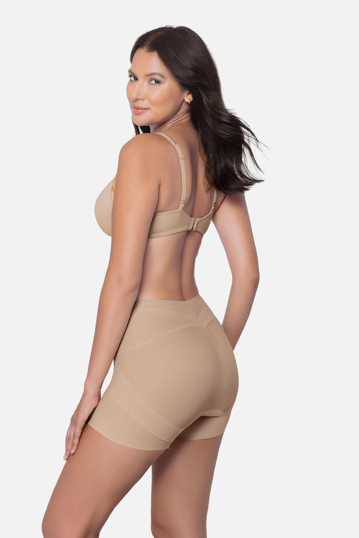 Woman turned left wearing a beige boy short shapewear pant