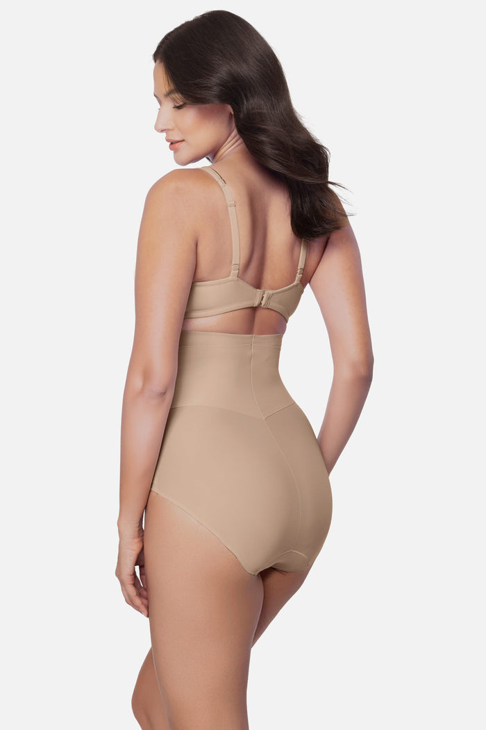 Woman turned left wearing a beige high waisted brief shapewear