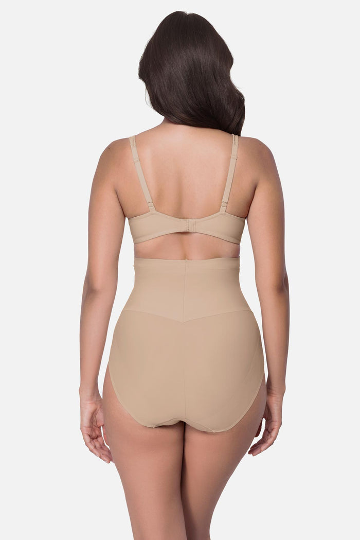 Woman turned away wearing a beige high waisted brief shapewear