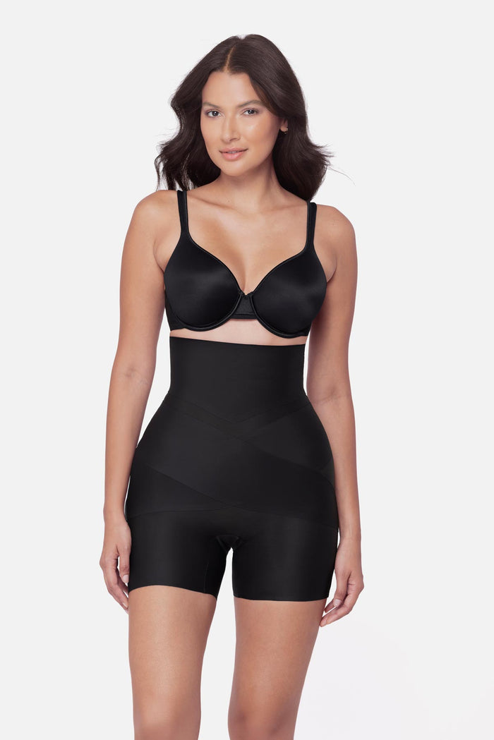 Woman wearing a high waisted mid thigh shapewear pant