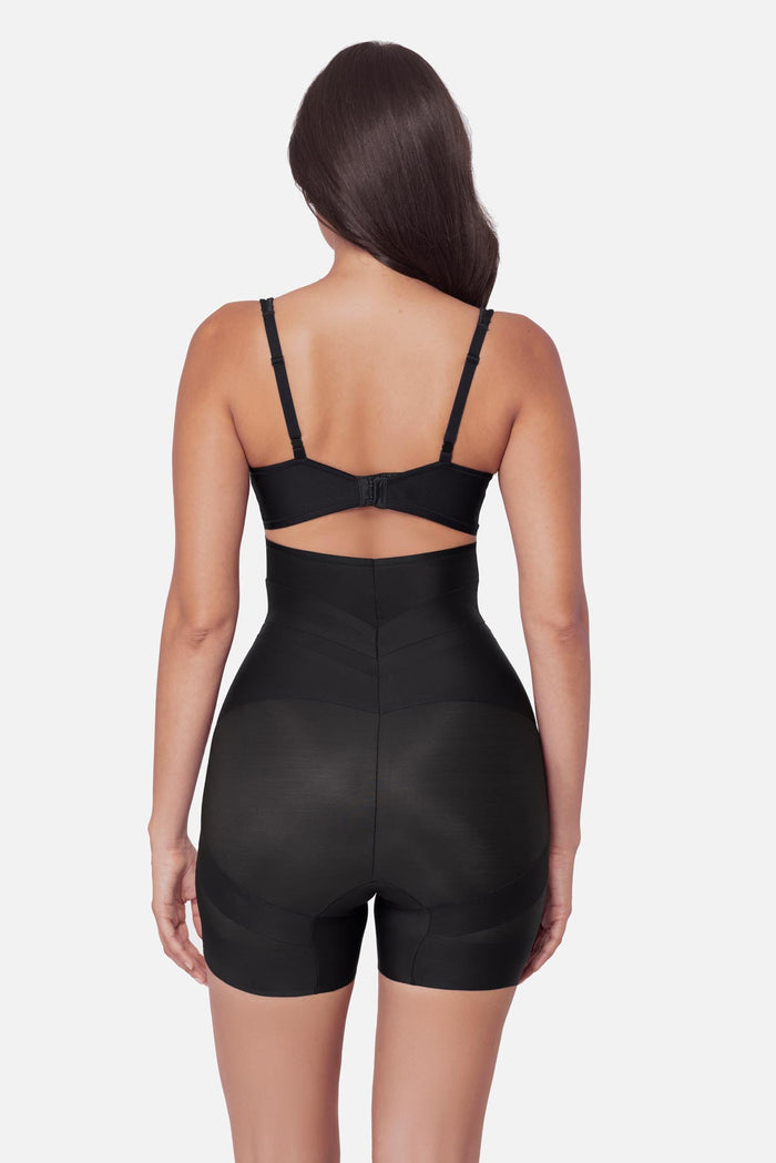Woman faced away wearing a high waisted mid-thigh shapewear pant