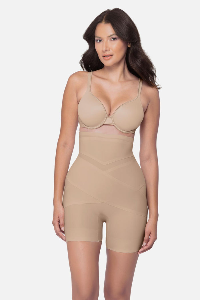 Woman wearing a beige high waisted mid-thigh shapewear pant