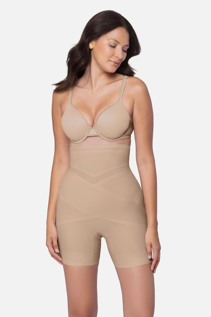 Woman wearing a beige high waisted mid-thigh shapewear pant