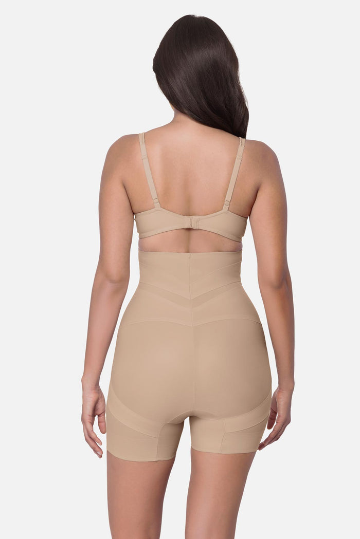 Woman turned away wearing a beige high waisted mid-thigh shapewear pant