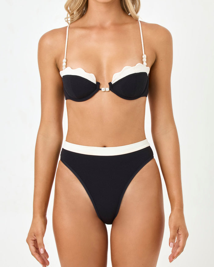 Close-up front view of a model wearing the LSPACE Black-Cream Sunrise Shell Bikini Top and Frenchi Bikini Bottom.