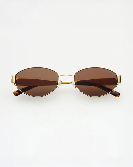Oval sunglasses with brown tinted lenses, a thin gold metal frame, and tortoiseshell temple tips, shown against a plain white background.