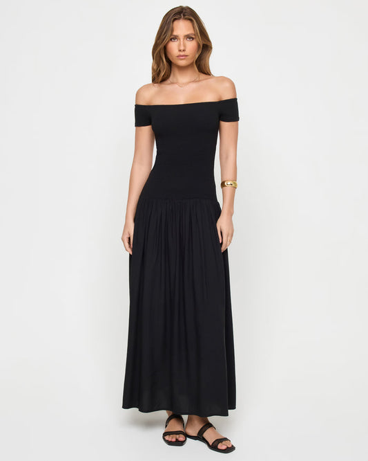 Front view of a model wearing the LSPACE Going Steady Midi in black, a black off-the-shoulder midi dress with fitted ribbed bodice and gathered full skirt.