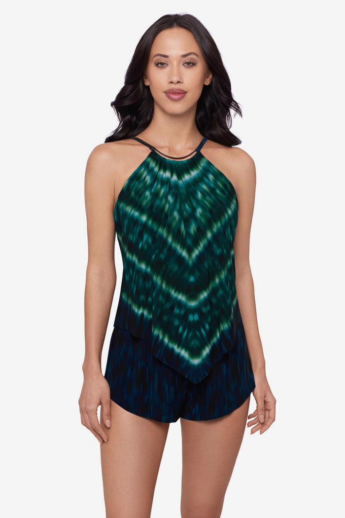 Woman wearing a green tie-dyed swim romper