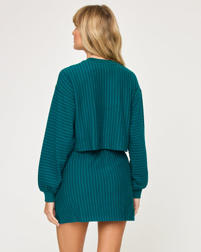 Back view of model wearing the Half Court Skirt in deep teal with matching deep teal Half Court Pullover.