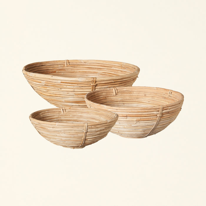 Set of three hand-woven cane bowls in different sizes.