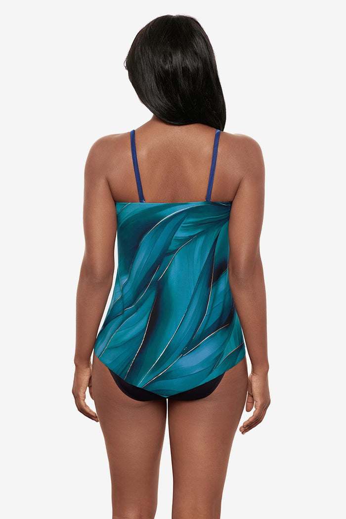 Woman wearing a multi-blue bandeau tankini top with gold detail