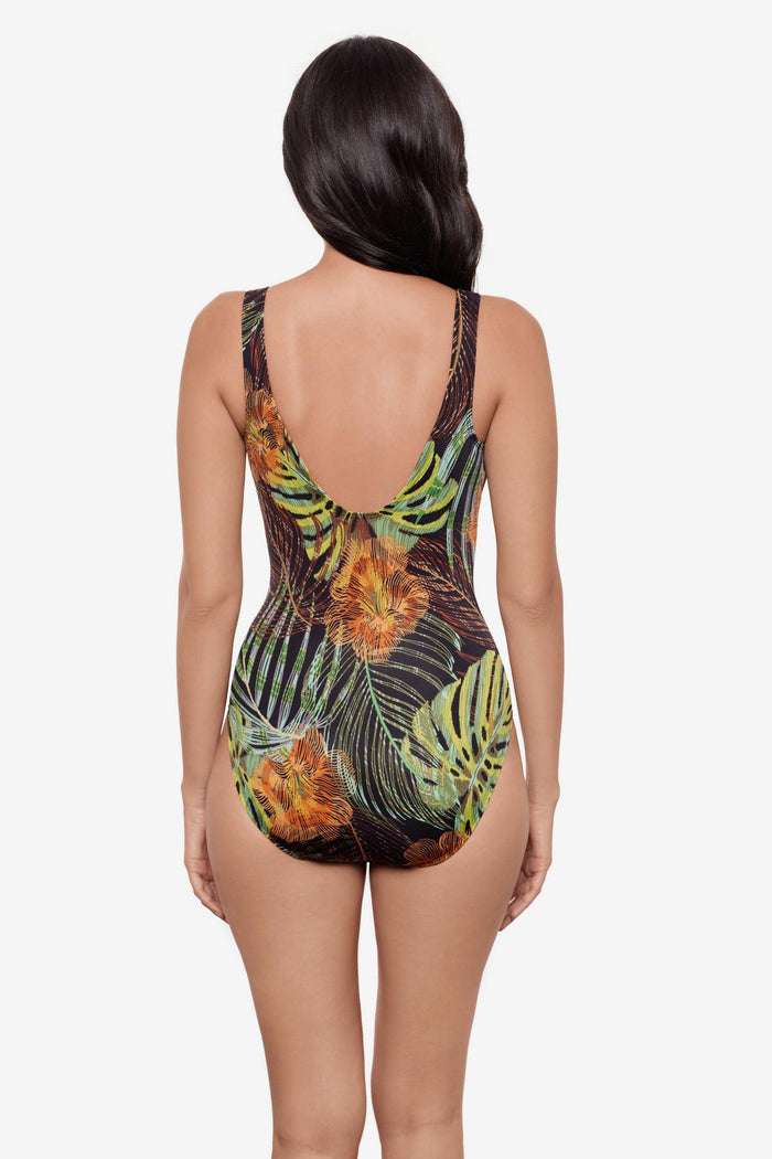 Woman turned away wearing a multicolored palm leaf print one-piece swimsuit