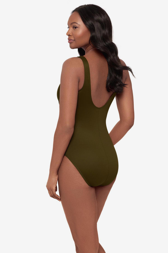 Woman turned left wearing a green one-piece swimsuit