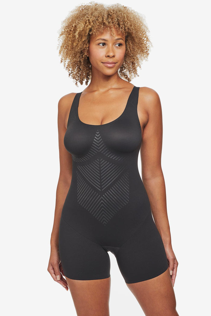 Woman wearing black one-piece thigh slimming shapewear