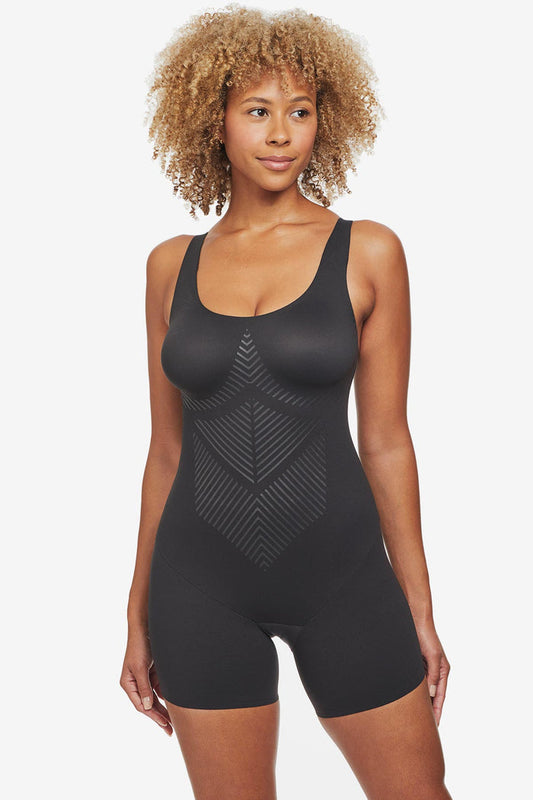 Woman wearing black one-piece thigh slimming shapewear