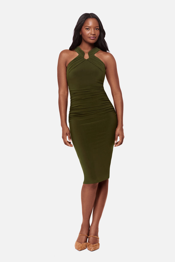 Woman wearing a dark green high neck mid length dress