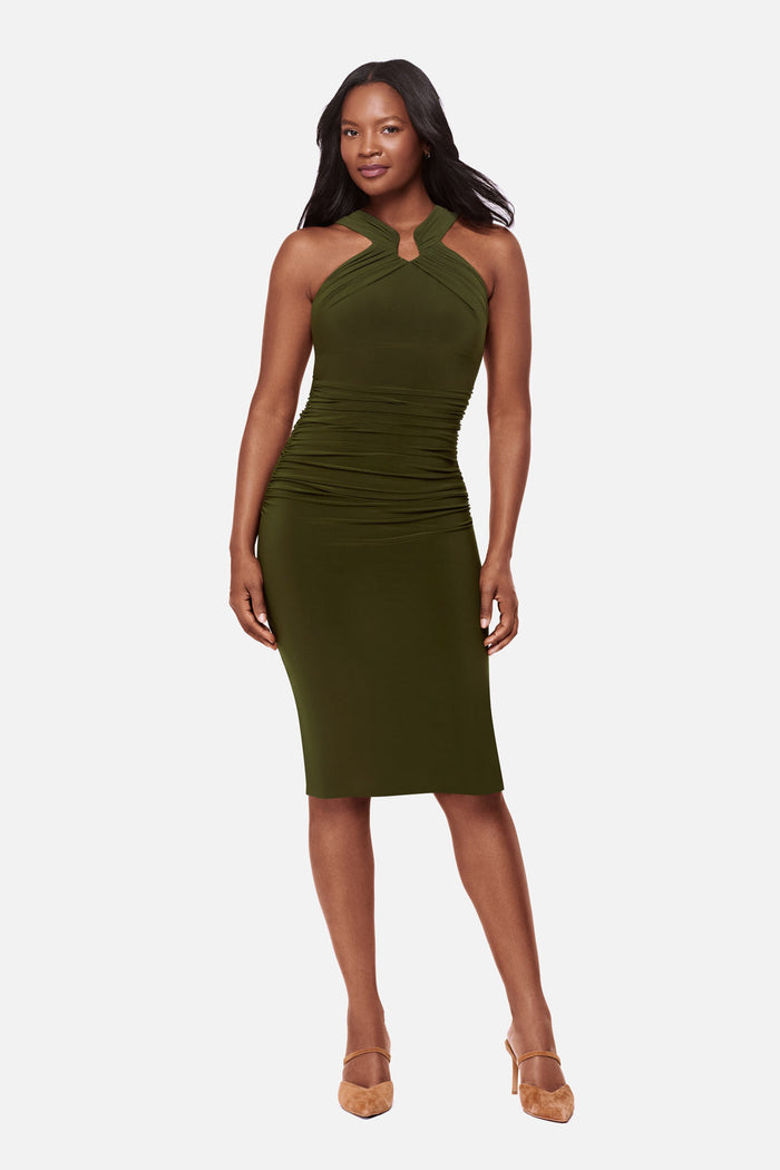 Woman wearing a dark green high neck mid length dress