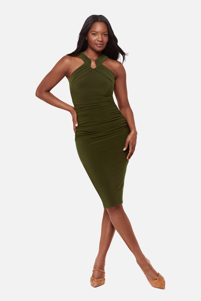 Woman wearing a dark green high neck mid length dress