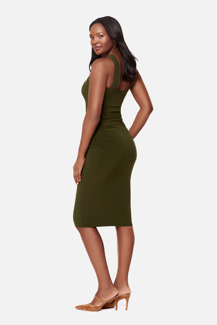 Woman turned left wearing a dark green high neck mid length dress