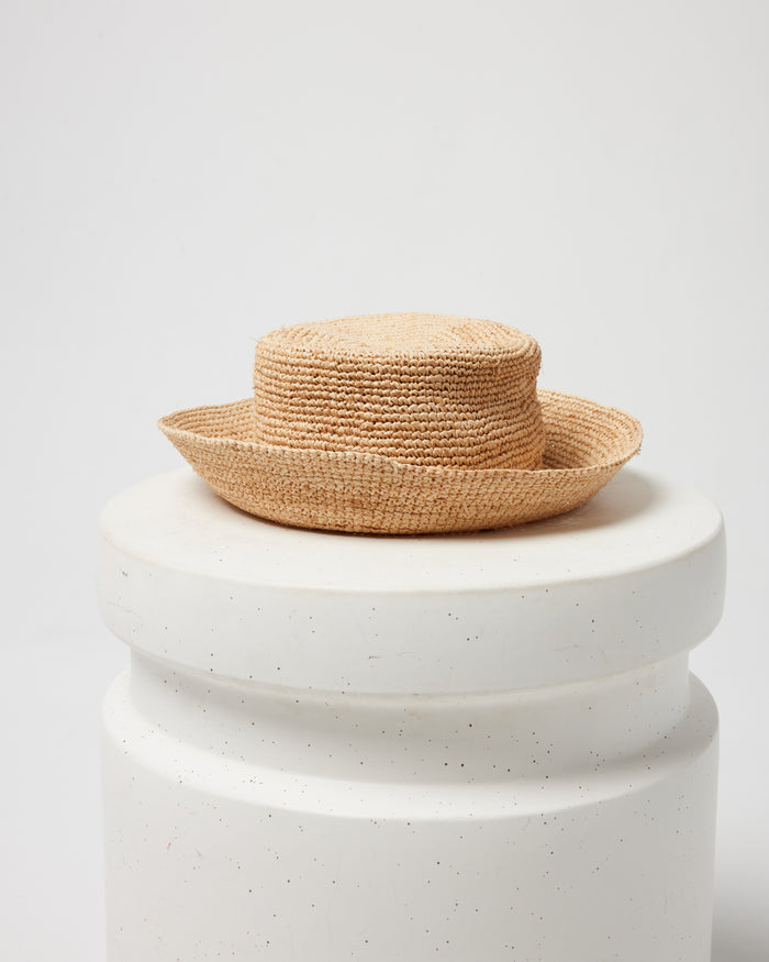 Off-model image of the Isadora Bucket Hat in natural on a white pedestal.