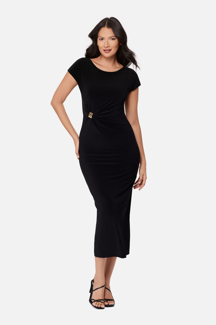 Woman wearing a black short sleeve dress with a gold tone accent on the side