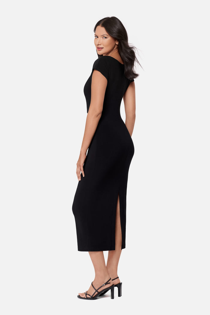 Woman turned left wearing a black short sleeve dress with a gold tone accent on the side