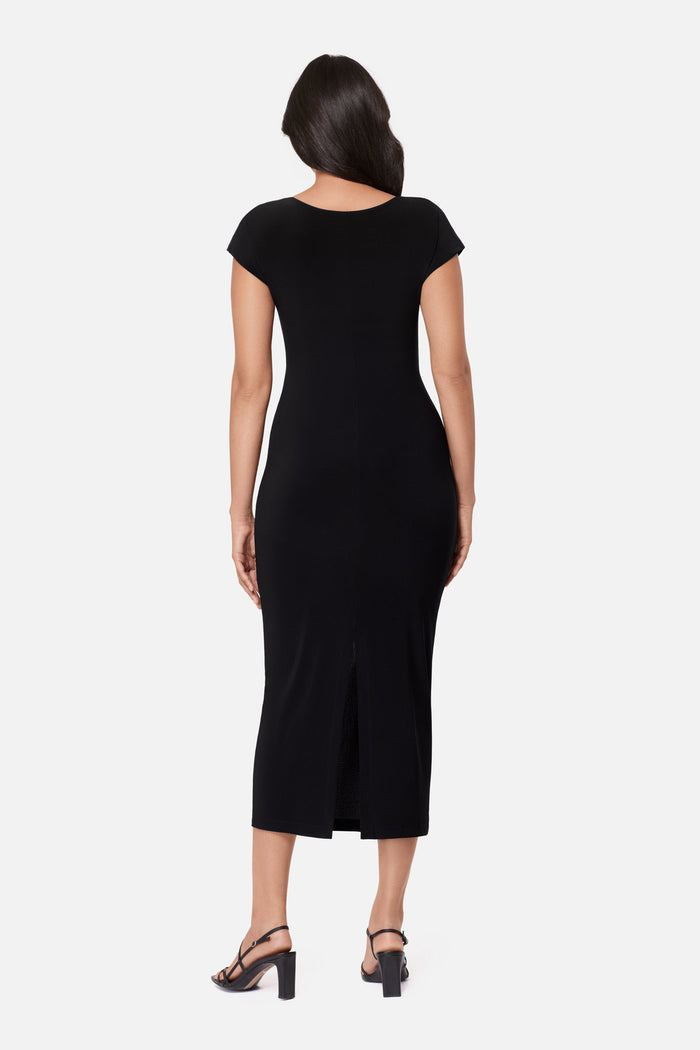 Woman turned away wearing a black short sleeve dress with a gold tone accent on the side
