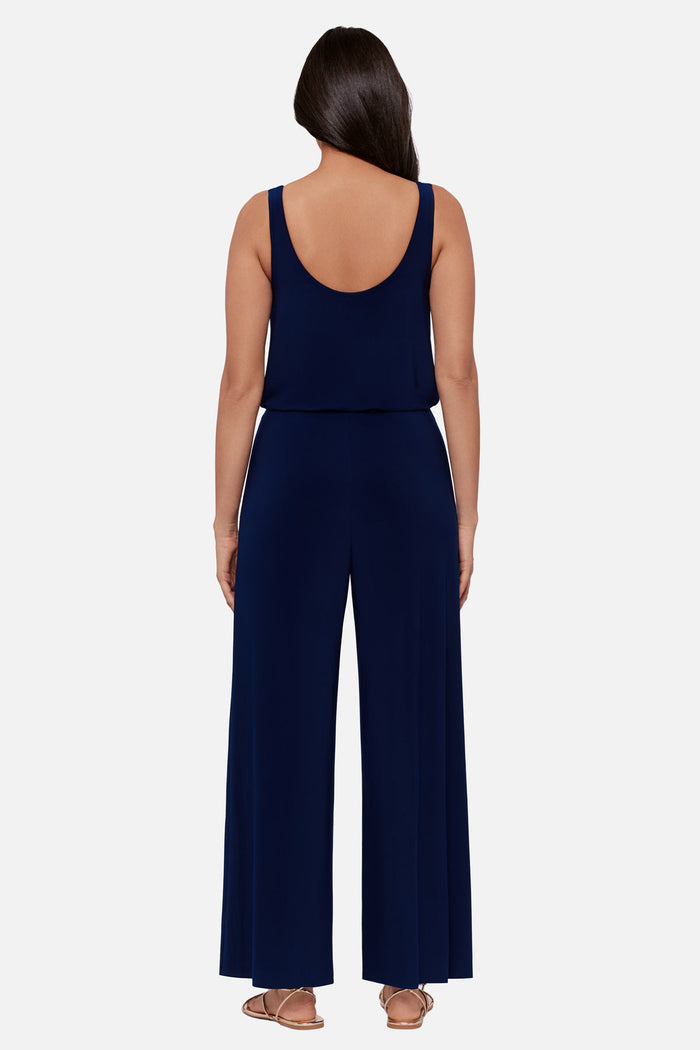 Woman faced away wearing a navy-blue sleeveless romper