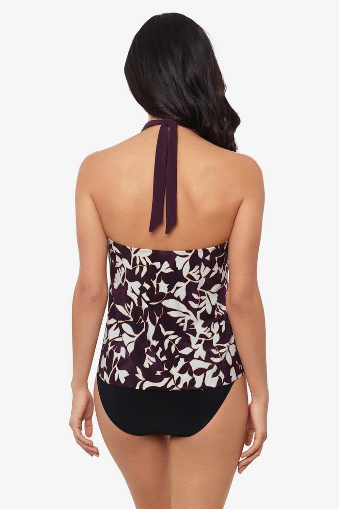 Woman tuned away wearing a multicolor tankini top with white flowers