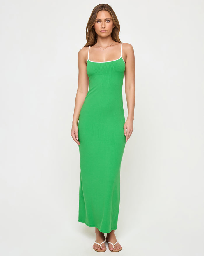 Full-length front view of a model wearing the LSPACE Jordana Dress in clover-cream, a form-fitting ribbed maxi dress in clover green with cream contrast trim at the neckline and spaghetti straps.