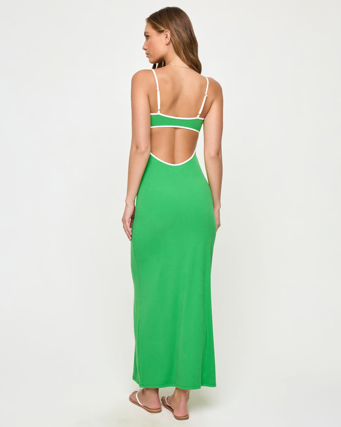 Back view of a model wearing the LSPACE Jordana Dress in clover-cream, showing the open back design with cream contrast trim framing the cutout.