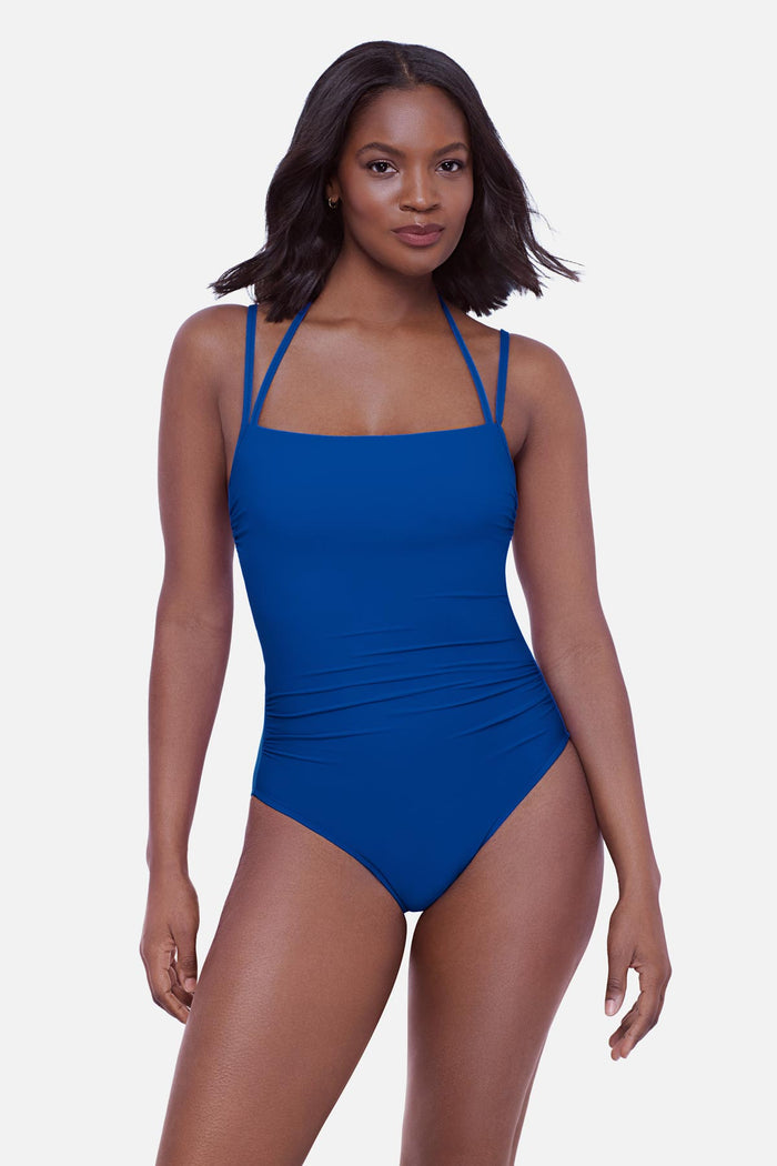 Woman wearing a blue one-piece swimsuit with double straps
