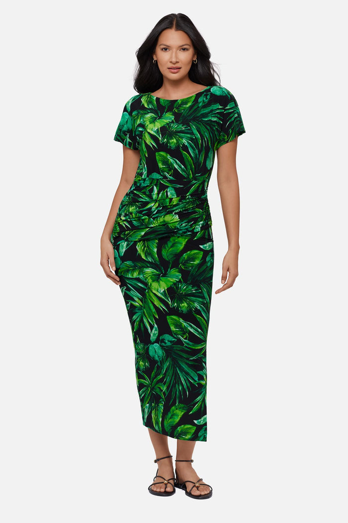Woman wearing a green palm leaf printed short sleeve full length dress