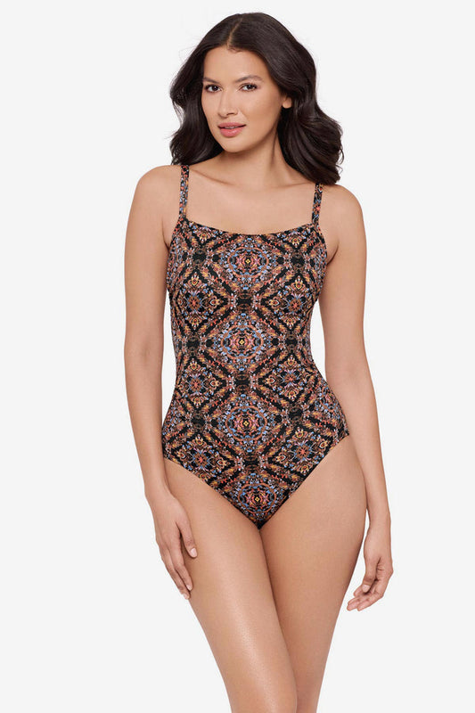Woman wearing a multicolor abstract one-piece swimsuit