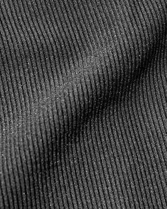 Close-up detail view of the LSPACE Kelly Bra in black-cream, highlighting the fabric texture and black-and-cream trim construction of the sports bra.