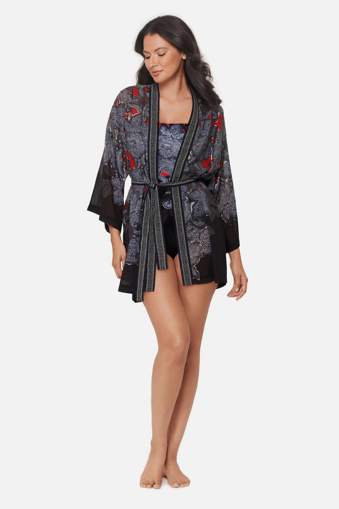 Woman wearing a multicolored abstract floral printed kimono swim cover up