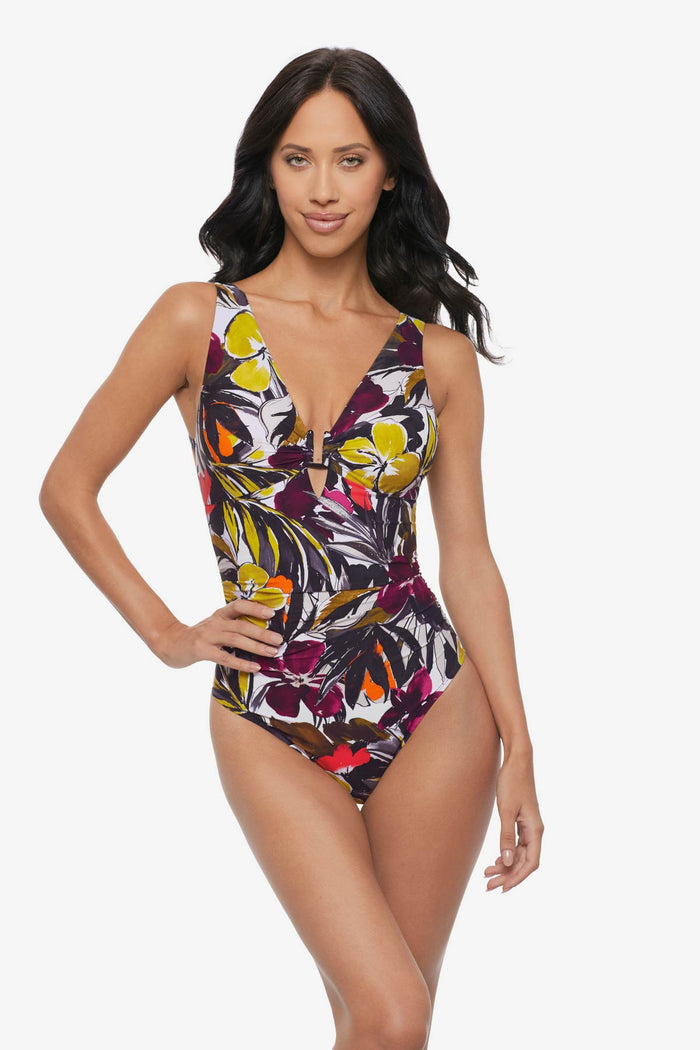 Woman wearing a multicolored floral printed one-piece swimsuit