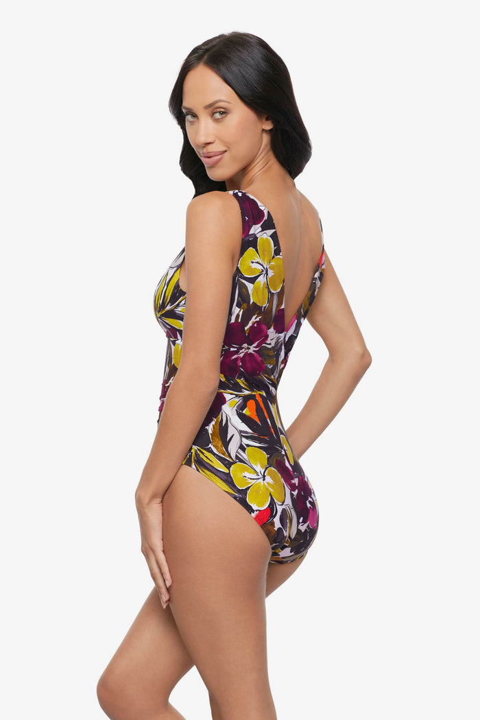 Woman turned left wearing a multicolored floral printed one-piece swimsuit
