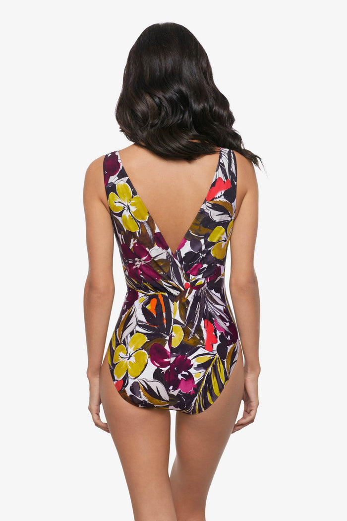 Woman turned away wearing a multicolored floral printed one-piece swimsuit